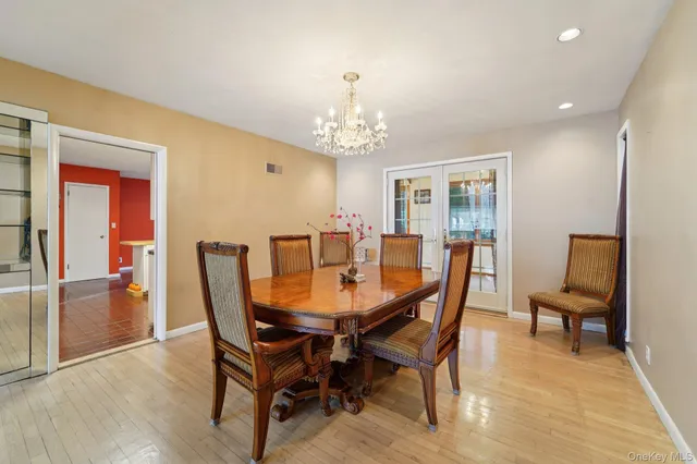 a view of a dining room with furniture and a chandelier