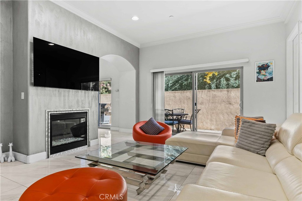 6920 Valmont Street, Unit 5 Tujunga, CA 91042 - Photo 18 of 69 a living room with furniture a fireplace and a flat screen tv