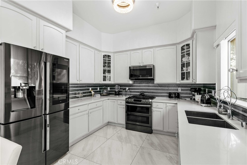 6920 Valmont Street, Unit 5 Tujunga, CA 91042 - Photo 31 of 69 a kitchen with stainless steel appliances a refrigerator stove and microwave