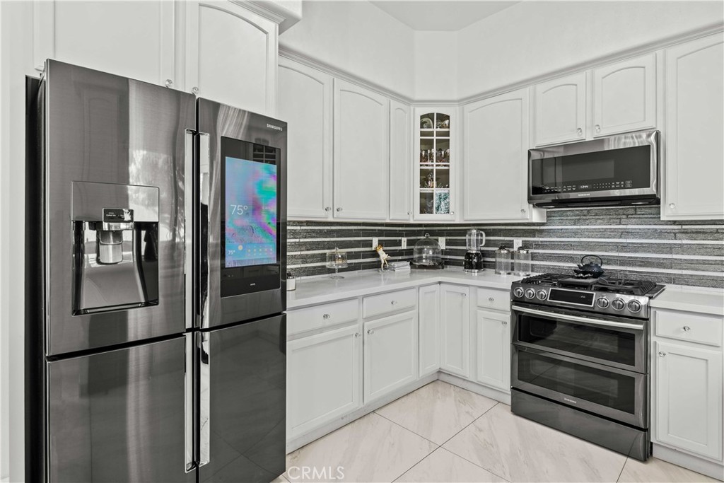 6920 Valmont Street, Unit 5 Tujunga, CA 91042 - Photo 34 of 69 a kitchen with stainless steel appliances a refrigerator stove and microwave