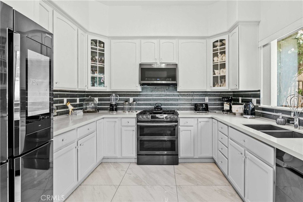 6920 Valmont Street, Unit 5 Tujunga, CA 91042 - Photo 35 of 69 a kitchen with stainless steel appliances granite countertop a stove top oven a sink and a refrigerator