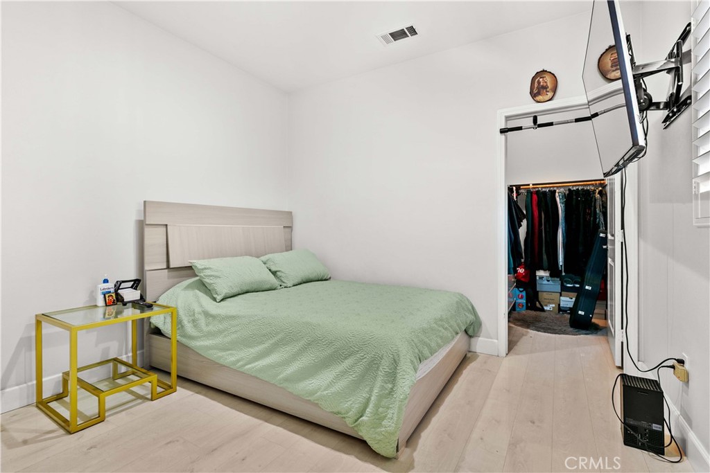 6920 Valmont Street, Unit 5 Tujunga, CA 91042 - Photo 43 of 69 a bedroom with a bed and a mirror