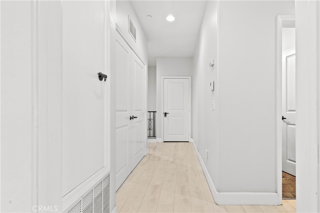 6920 Valmont Street, Unit 5 Tujunga, CA 91042 - Photo 48 of 69 a view of a hallway with wooden floor and a bathroom