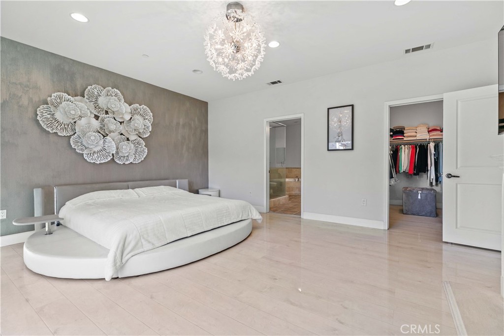 6920 Valmont Street, Unit 5 Tujunga, CA 91042 - Photo 51 of 69 a bedroom with a bed and a chandelier