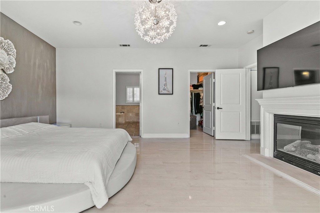 6920 Valmont Street, Unit 5 Tujunga, CA 91042 - Photo 52 of 69 a spacious bedroom with a bed and a fireplace