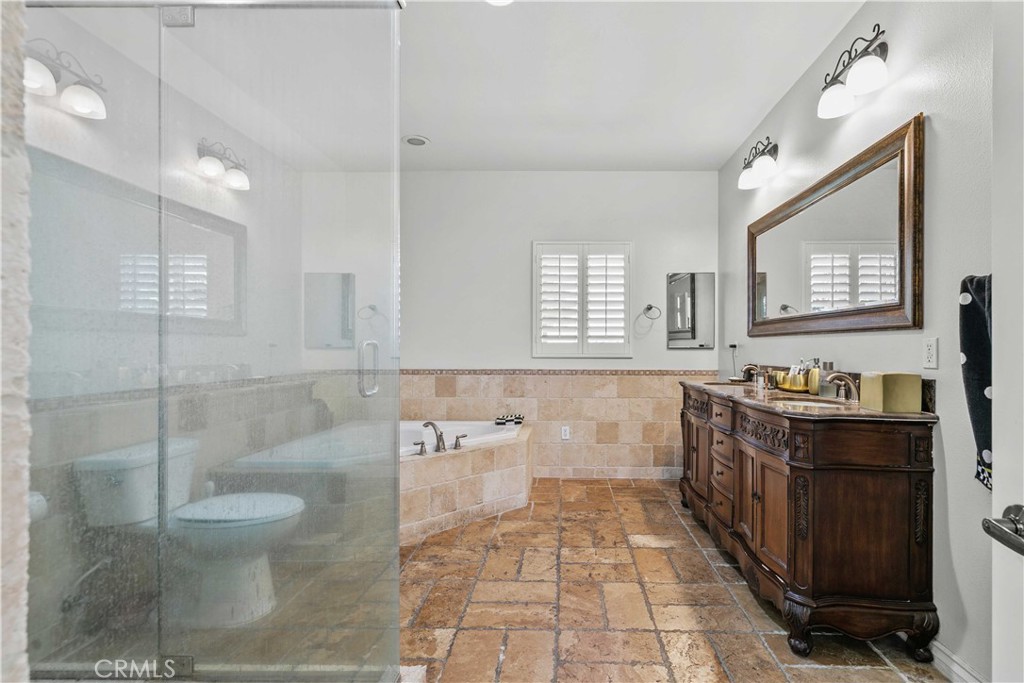6920 Valmont Street, Unit 5 Tujunga, CA 91042 - Photo 57 of 69 a spacious bathroom with a bathtub sink mirror and toilet