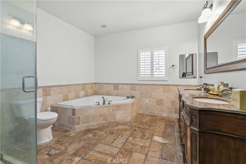 6920 Valmont Street, Unit 5 Tujunga, CA 91042 - Photo 58 of 69 a bathroom with a sink toilet and mirror