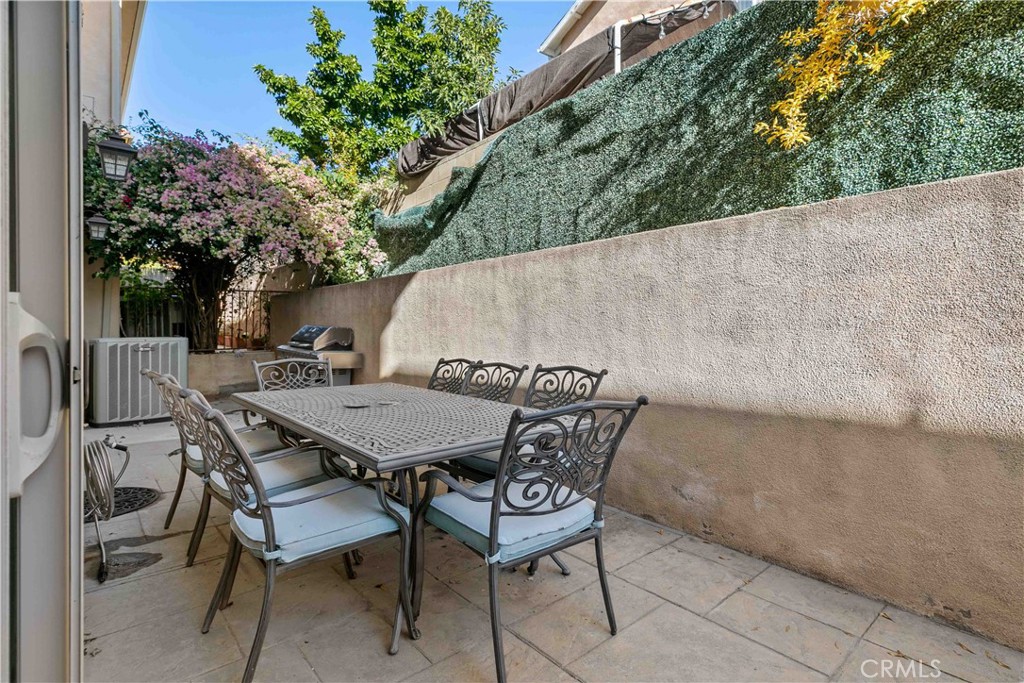 6920 Valmont Street, Unit 5 Tujunga, CA 91042 - Photo 63 of 69 a backyard of a house with table and chairs