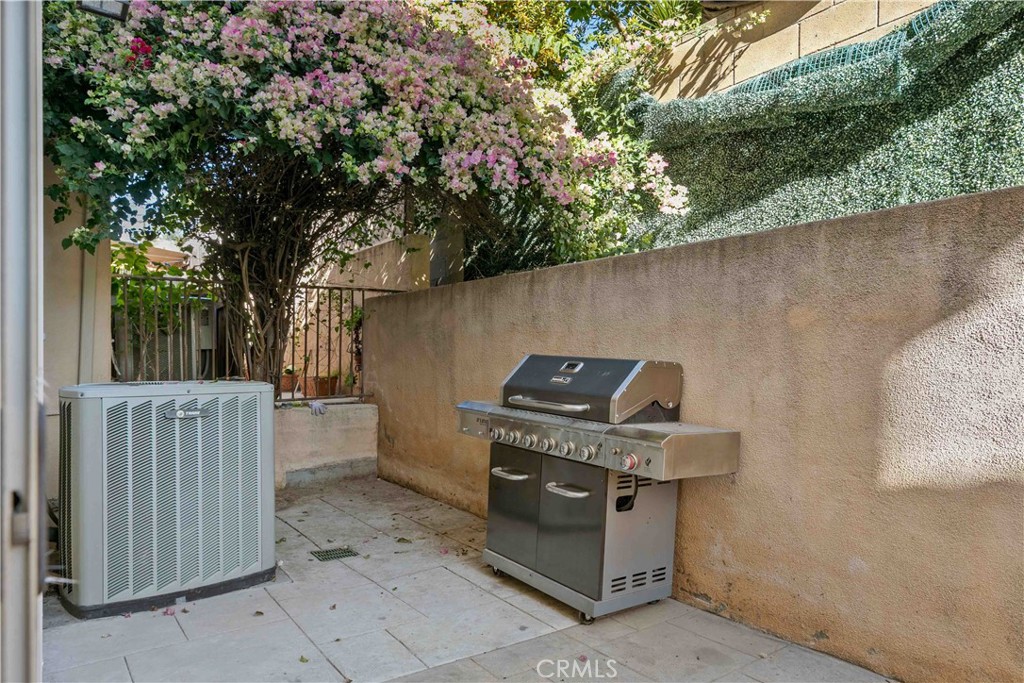 6920 Valmont Street, Unit 5 Tujunga, CA 91042 - Photo 66 of 69 a backyard of a house with barbeque oven and outdoor seating