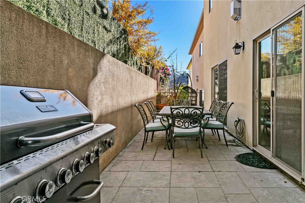 6920 Valmont Street, Unit 5 Tujunga, CA 91042 - Photo 67 of 69 a view of a patio with table and chairs and potted plants