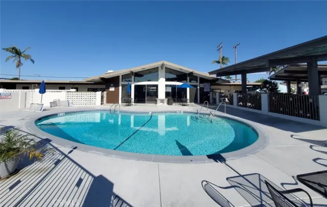 a view of a patio with table and chairs