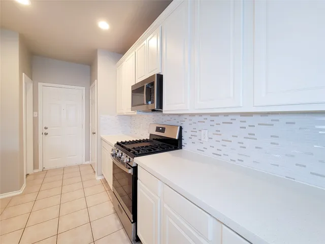 a kitchen with a sink and a stove top oven