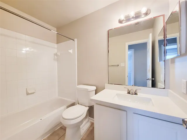 an empty room with a window and a ceiling fan