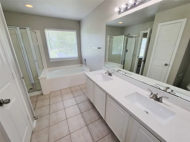 a white bath tub sitting next to a shower