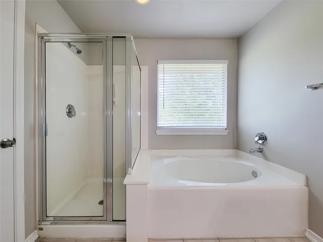 a bathroom with double vanity sinks and a mirror