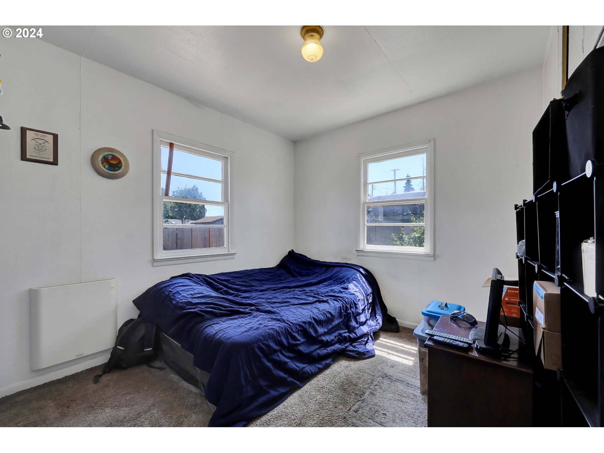 1925 15th Street Springfield, OR 97477 - Photo 10 of 26 a bedroom with a bed a flat screen tv and a window