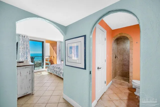 a bedroom with a large bed and a large window