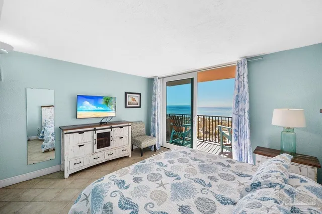 a bedroom with a large bed and a chandelier