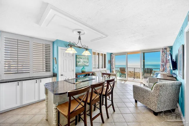 a kitchen with a table chairs and window