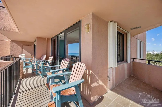a view of a balcony with furniture