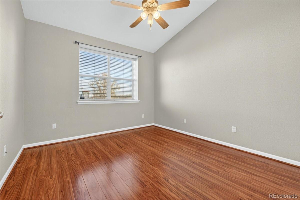 5800 Tower Road, Unit 2411 Denver, CO 80249 - Photo 14 of 28 wooden floor in an empty room with a window