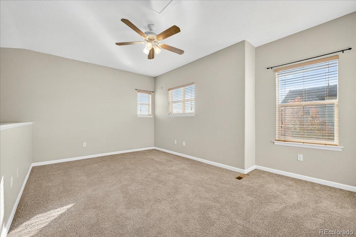 5800 Tower Road, Unit 2411 Denver, CO 80249 - Photo 16 of 28 an empty room with windows and fan