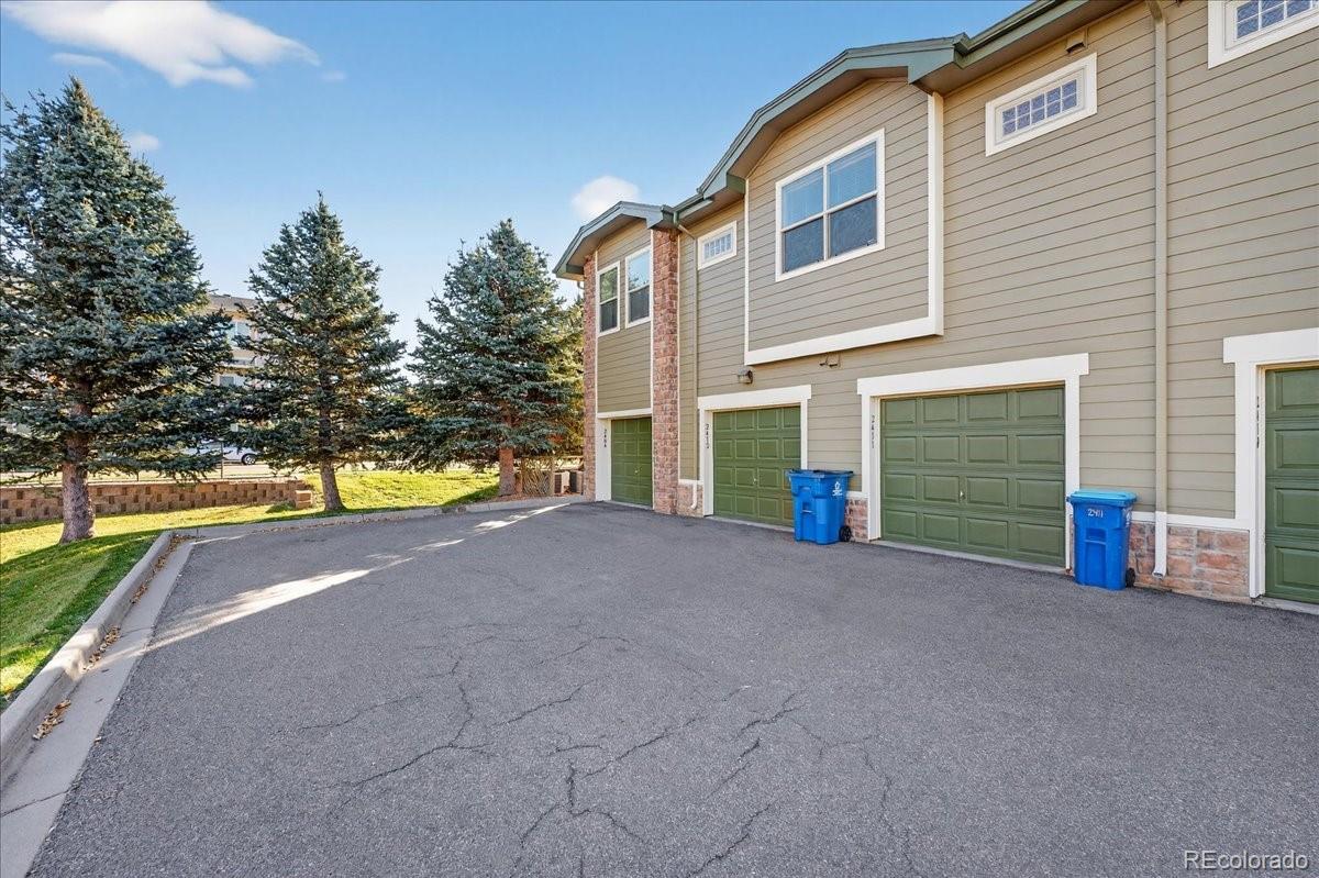 5800 Tower Road, Unit 2411 Denver, CO 80249 - Photo 19 of 28 a view of a house with a yard and a garage