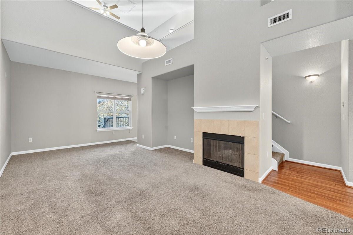 5800 Tower Road, Unit 2411 Denver, CO 80249 - Photo 4 of 28 an empty room with windows and fireplace