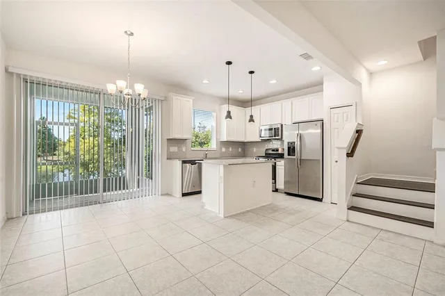 a kitchen with stainless steel appliances a refrigerator sink and cabinets