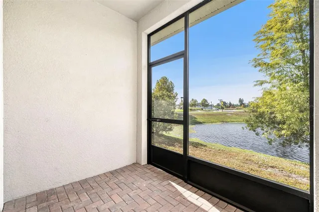 a view of balcony with floor to ceiling window and wooden floor