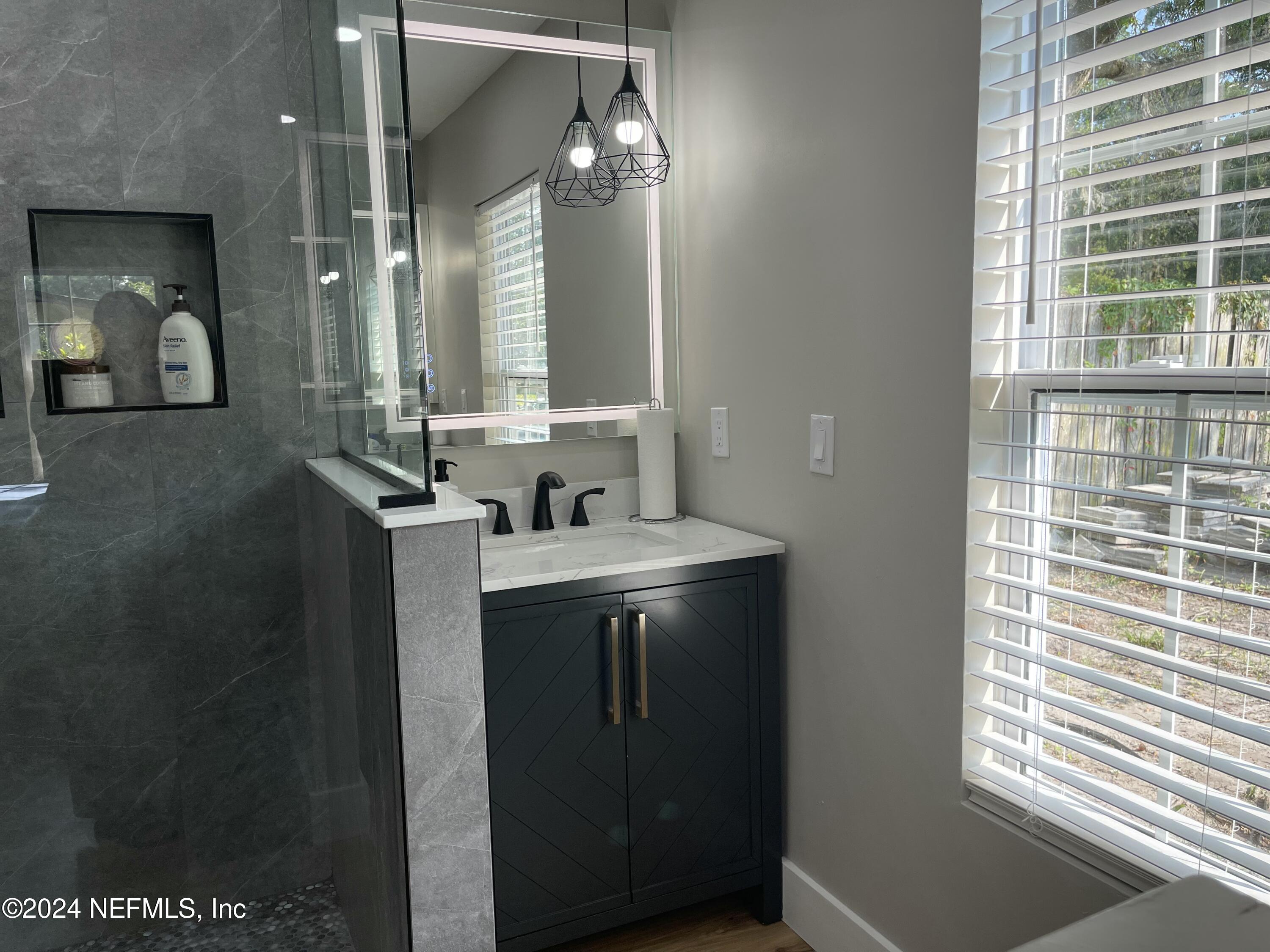 7566 Old Kings Road South Jacksonville, FL 32217 - Photo 17 of 30 a view of a bathroom with a sink and mirror