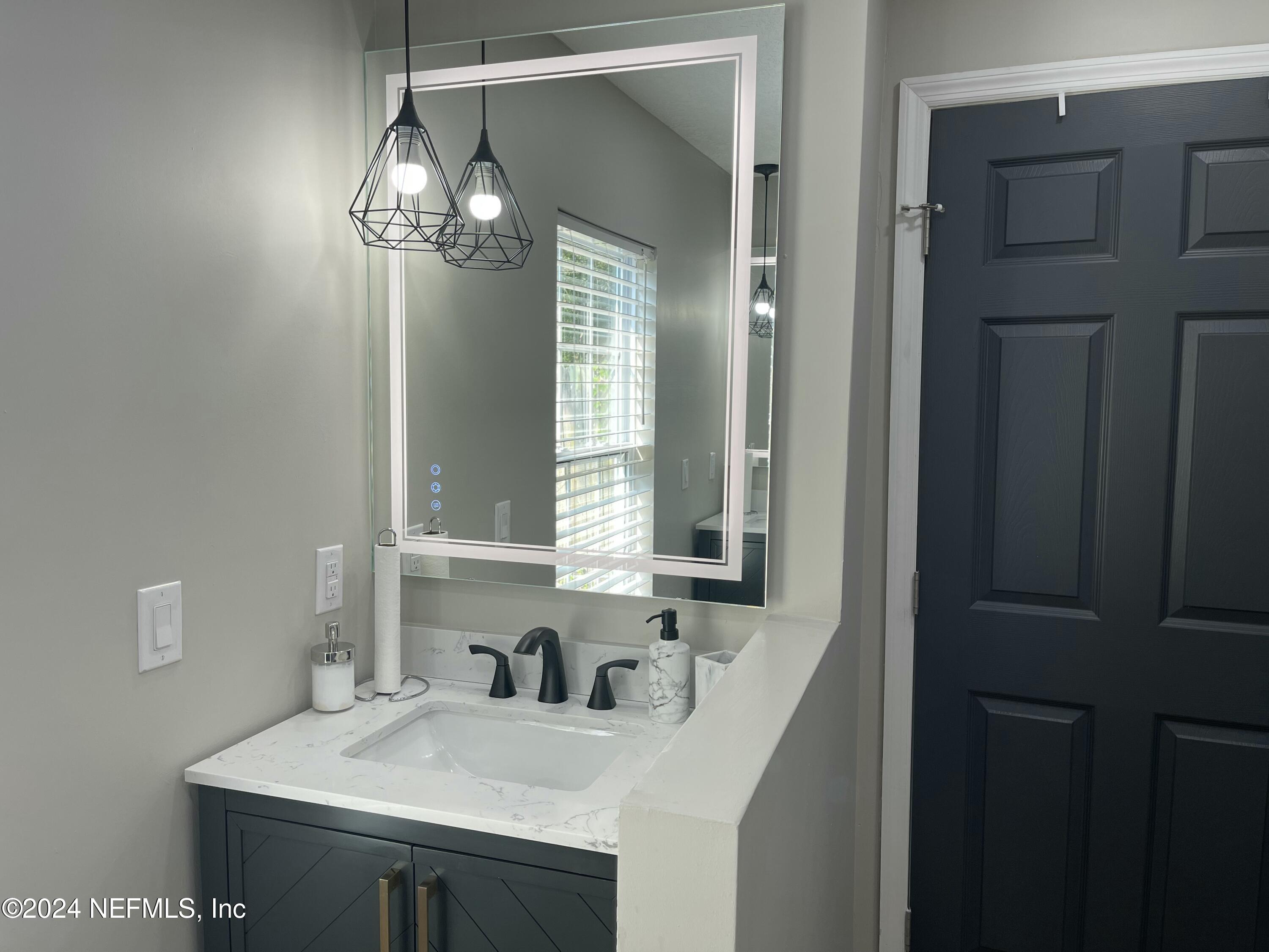 7566 Old Kings Road South Jacksonville, FL 32217 - Photo 18 of 30 a bathroom with a sink and a mirror