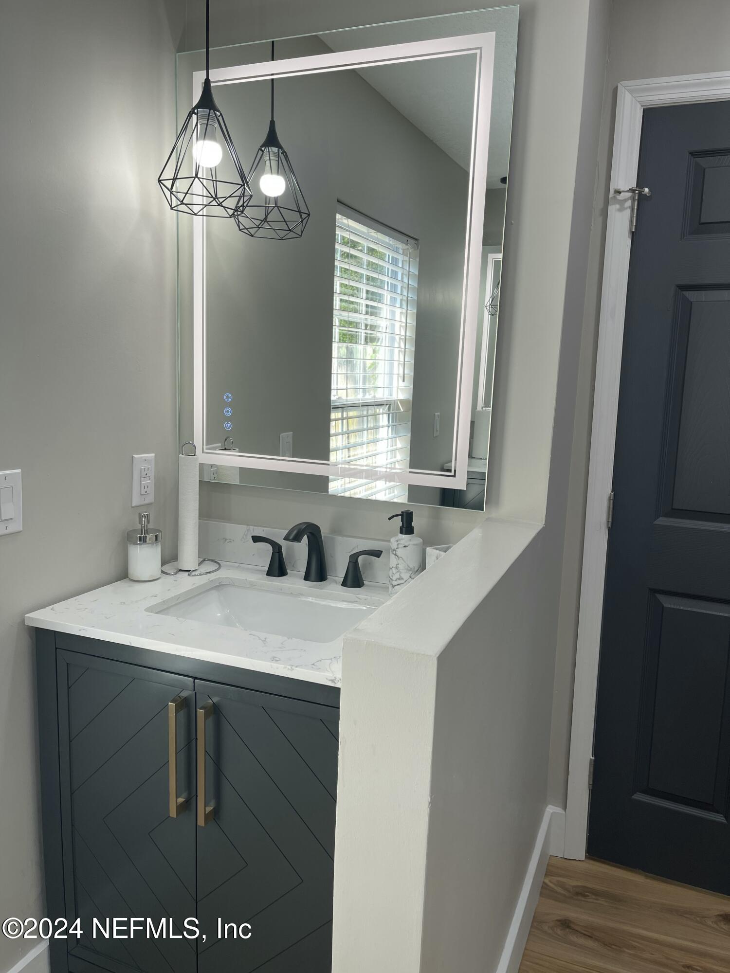 7566 Old Kings Road South Jacksonville, FL 32217 - Photo 19 of 30 a bathroom with a sink and a mirror
