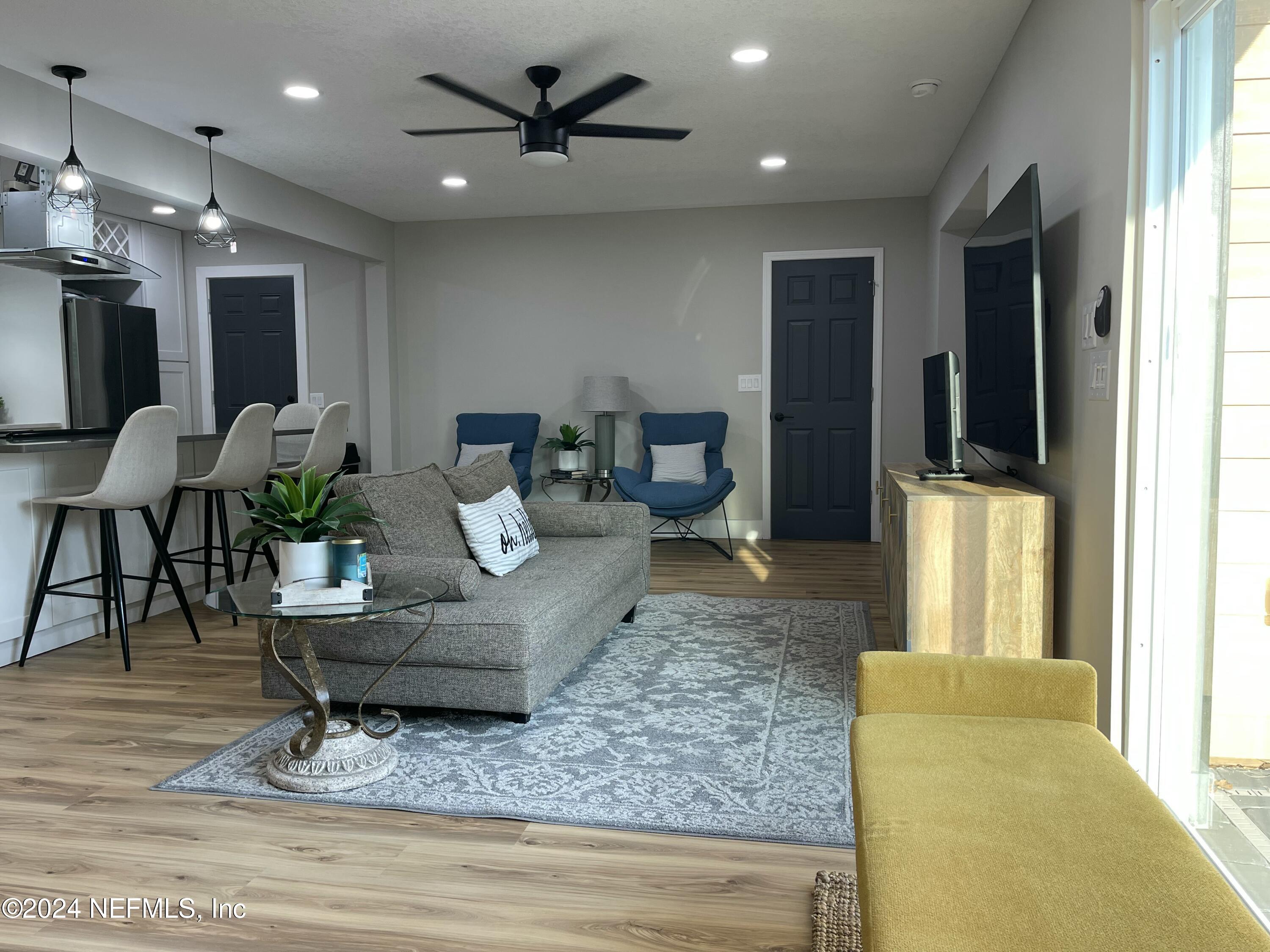 7566 Old Kings Road South Jacksonville, FL 32217 - Photo 2 of 30 a living room with furniture and a flat screen tv