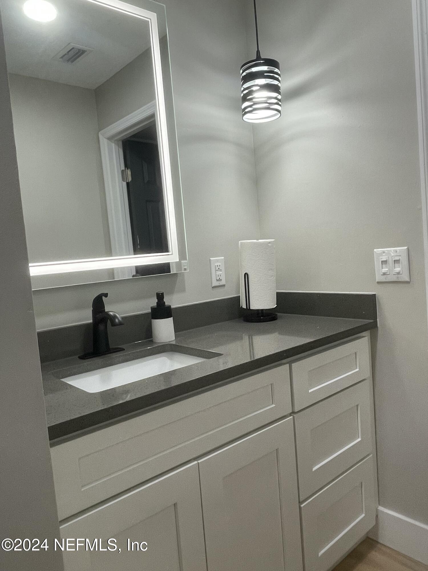 7566 Old Kings Road South Jacksonville, FL 32217 - Photo 27 of 30 a bathroom with a sink and a mirror