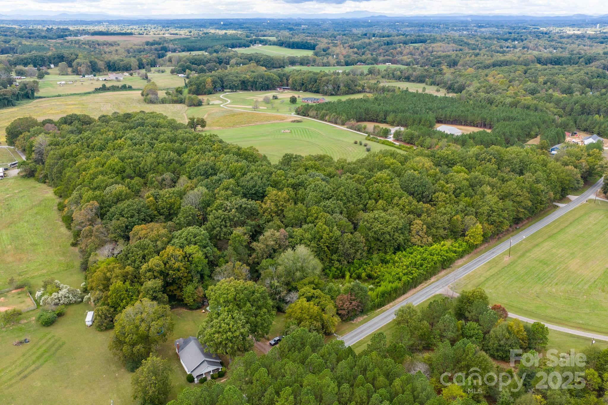 1615 Fox Dairy Road, Unit 12 Newton, NC 28658 - Photo 22 of 35 a view of a lush green field with lots of buildings in the background