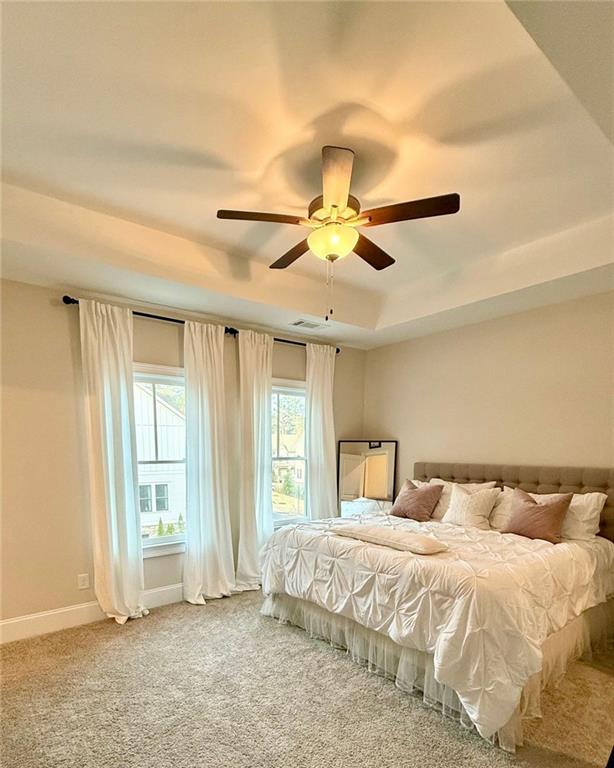 2098 Cortland Road, Unit 31 Alpharetta, GA 30004 - Photo 15 of 16 a bedroom with a large bed and a ceiling fan