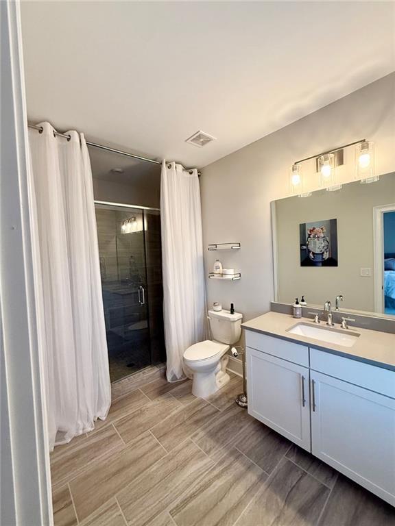2098 Cortland Road, Unit 31 Alpharetta, GA 30004 - Photo 16 of 16 a bathroom with a double vanity sink toilet and shower