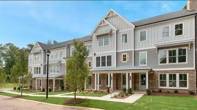 front view of a residential apartment building with a yard