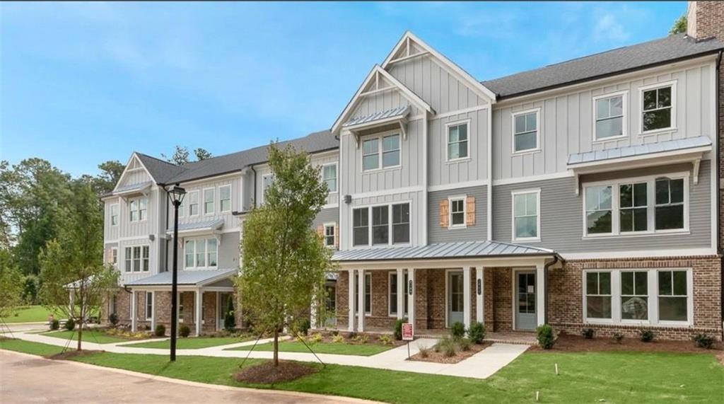 2098 Cortland Road, Unit 31 Alpharetta, GA 30004 - Photo 2 of 16 front view of a residential apartment building with a yard