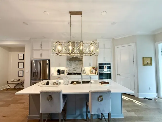 a view of a kitchen counter space a sink stainless steel appliances and cabinets