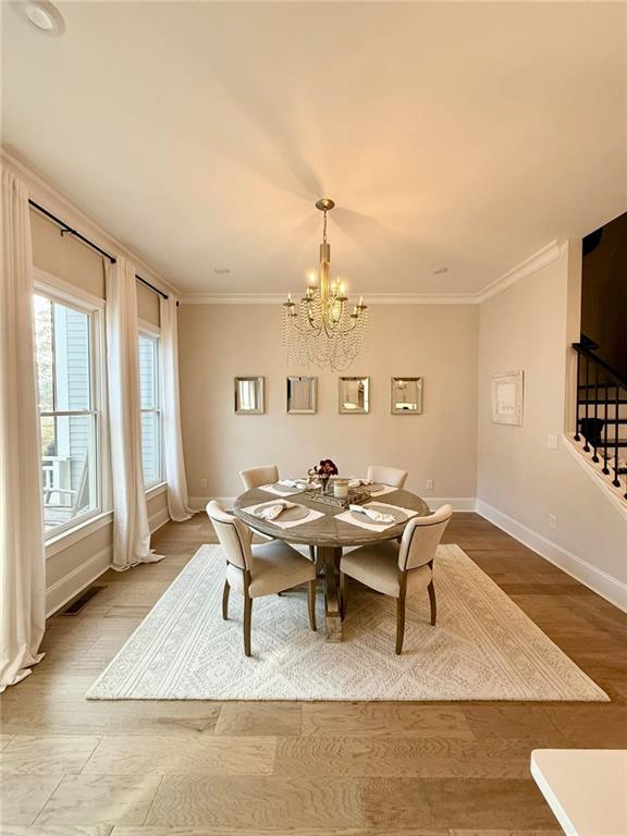 2098 Cortland Road, Unit 31 Alpharetta, GA 30004 - Photo 8 of 16 a view of a dining room with furniture a chandelier and wooden floor