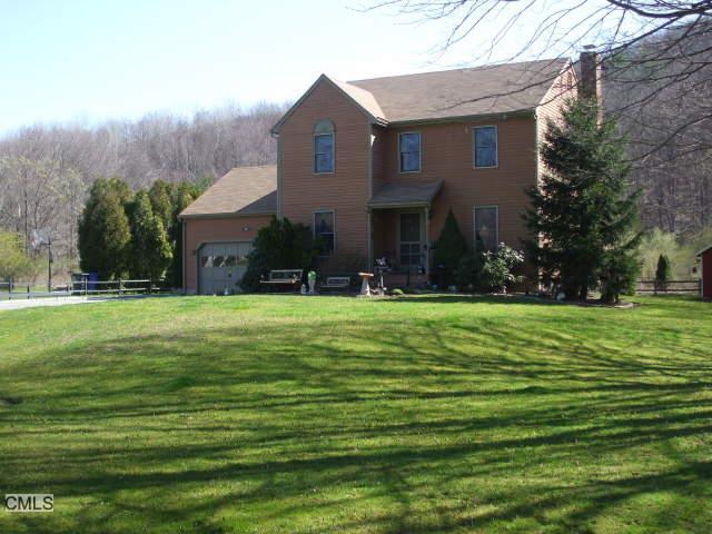 100 Browns Forge Road New Milford, CT 06755 - Photo 1 of 1 a front view of house with yard and green space