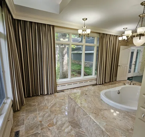 a view of a bathroom with a tub and shower