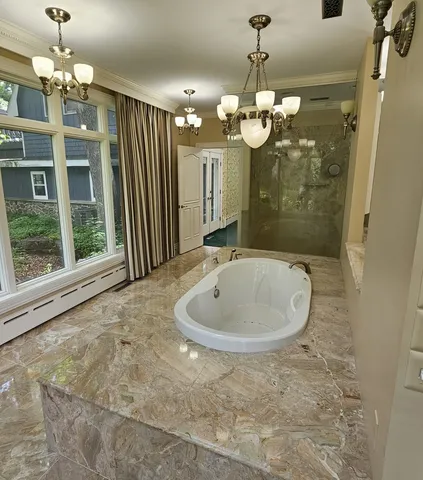 a bathroom with a bathtub sink and mirror