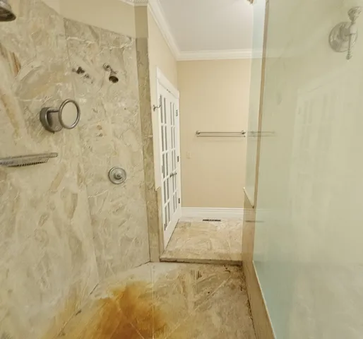 a bathroom with a granite countertop shower
