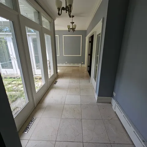 a view of a hallway view with furniture and a window