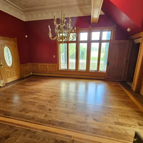 a view of room with window and wooden floor