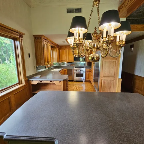 a view of a kitchen with furniture and chandelier