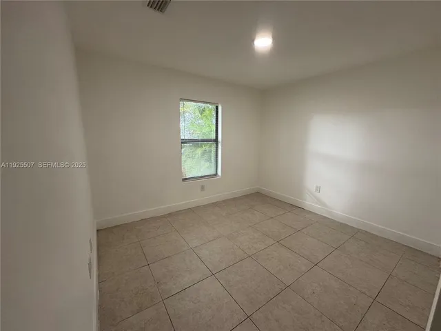 an empty room with a empty space and windows